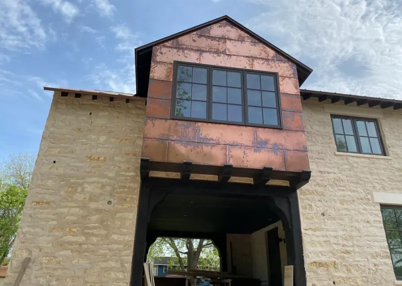 Copper metal panel facade on a stone building for Roof Repair in Tucson Estates